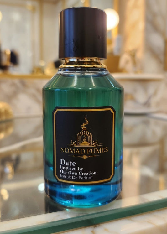 Bottle of Nomad Fumes perfume on a reflective surface with a blurred background