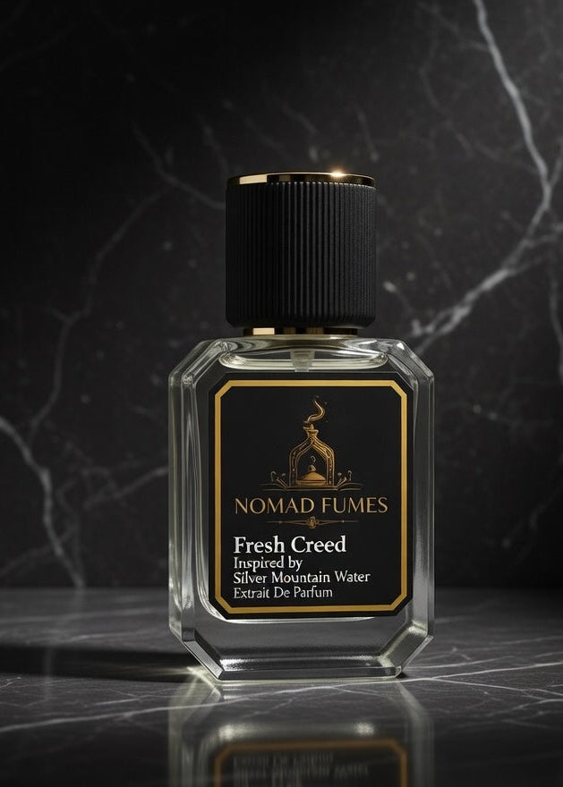 Perfume bottle labeled 'Nomad Fumes' on a dark marble surface with a dark background