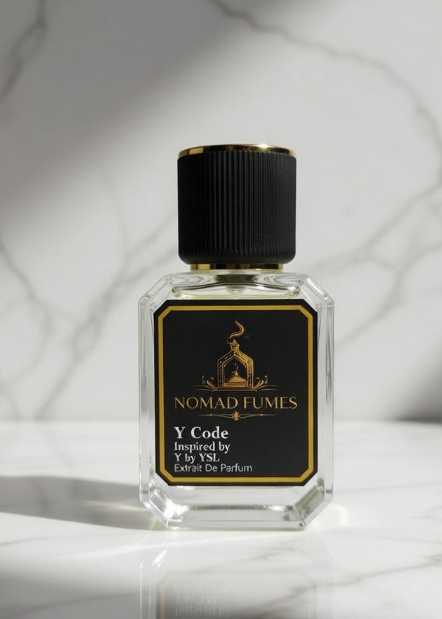 Perfume bottle with black cap and gold label on a marble surface