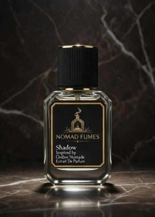 Perfume bottle labeled 'Nomad Fumes' on a dark marble surface