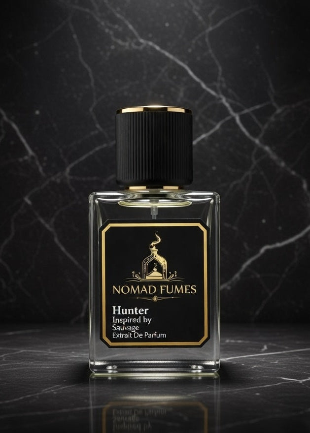 Perfume bottle labeled 'Nomad Fumes' on a dark marble surface