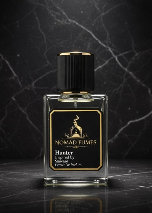 Perfume bottle labeled 'Nomad Fumes' on a dark marble surface